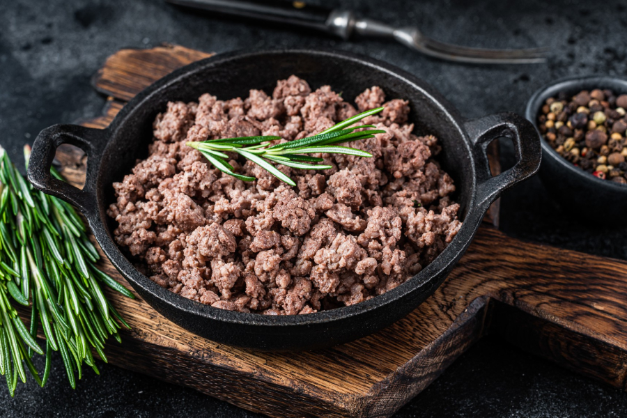 Cooked lean ground beef in a skillet, ready for a meal.